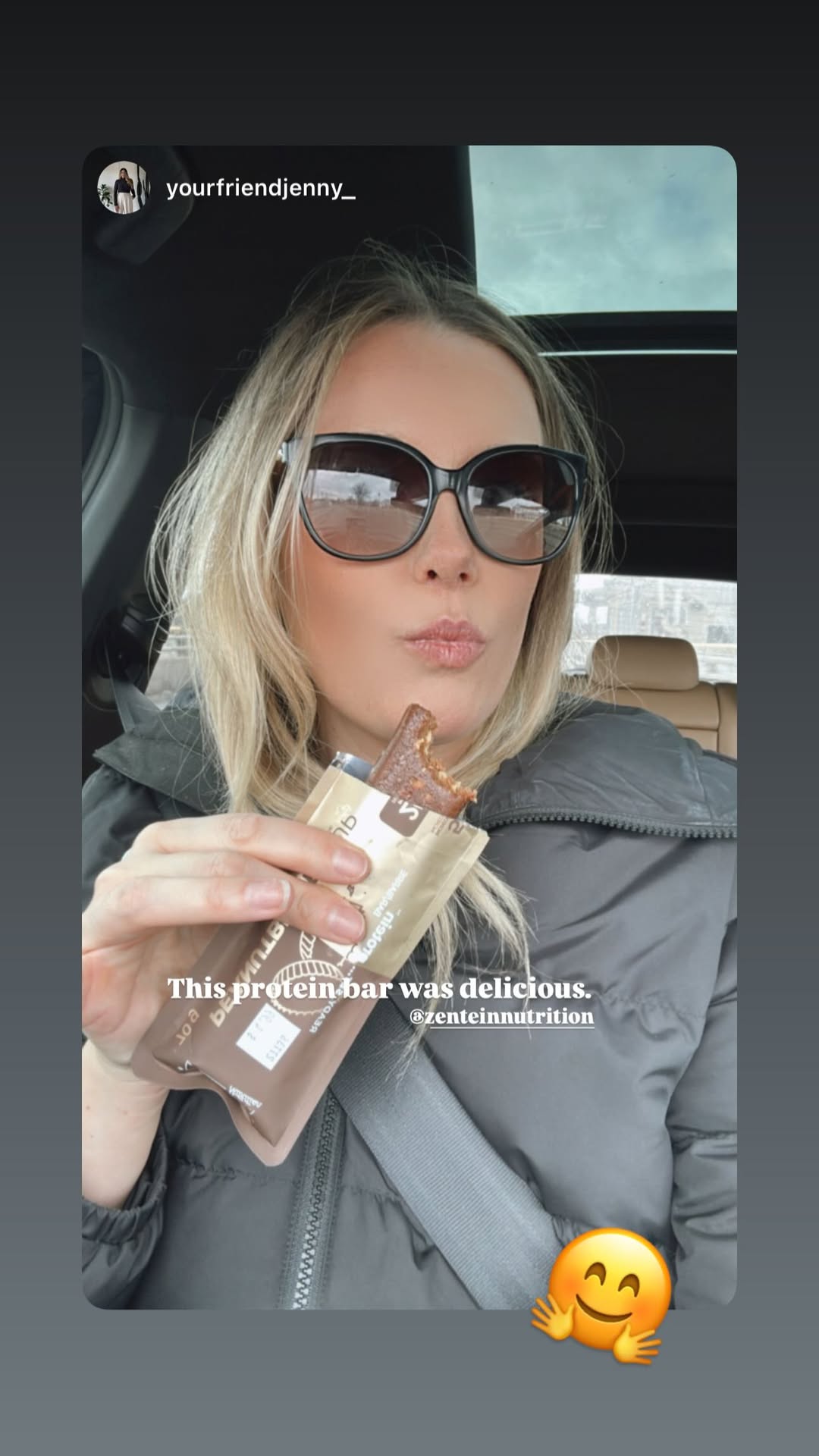 Jenny holds Peanut Butter Cup after taking a bite in a car.