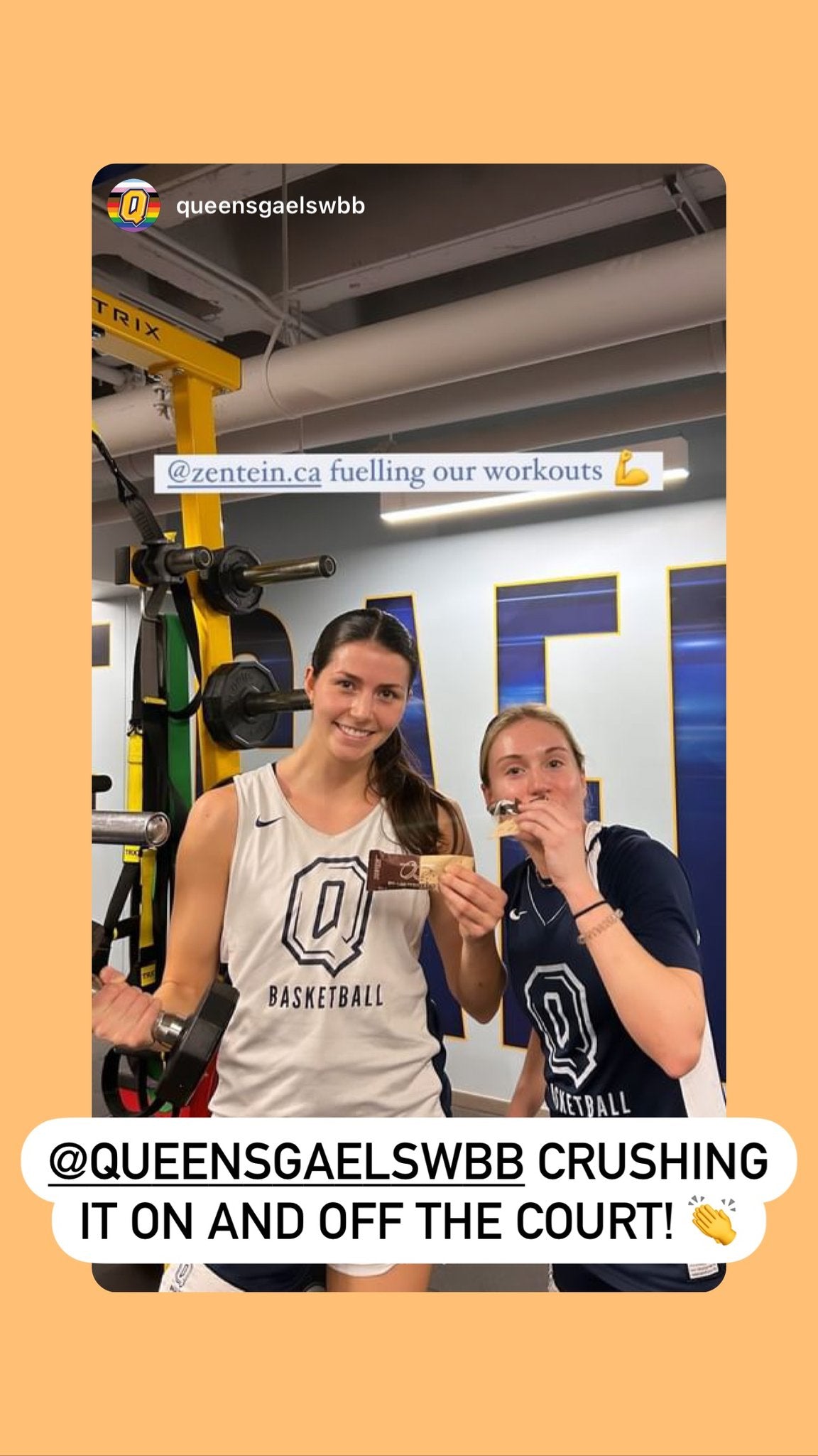 Two Queen’s basketball teammates hold Peanut Butter Cup in the training room.