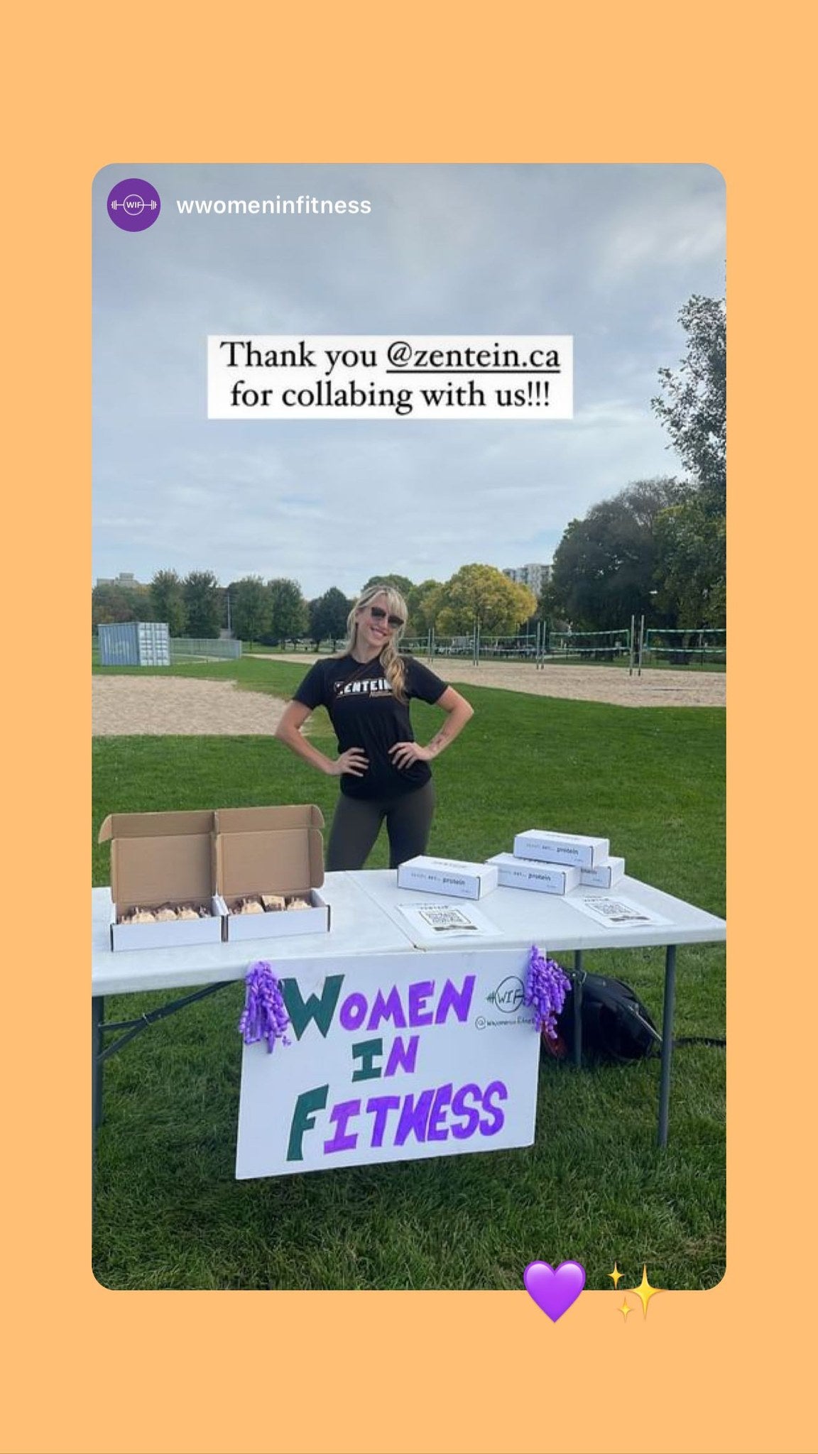 A Women in Fitness community member stands behind an outdoor table displaying Zentein boxes.